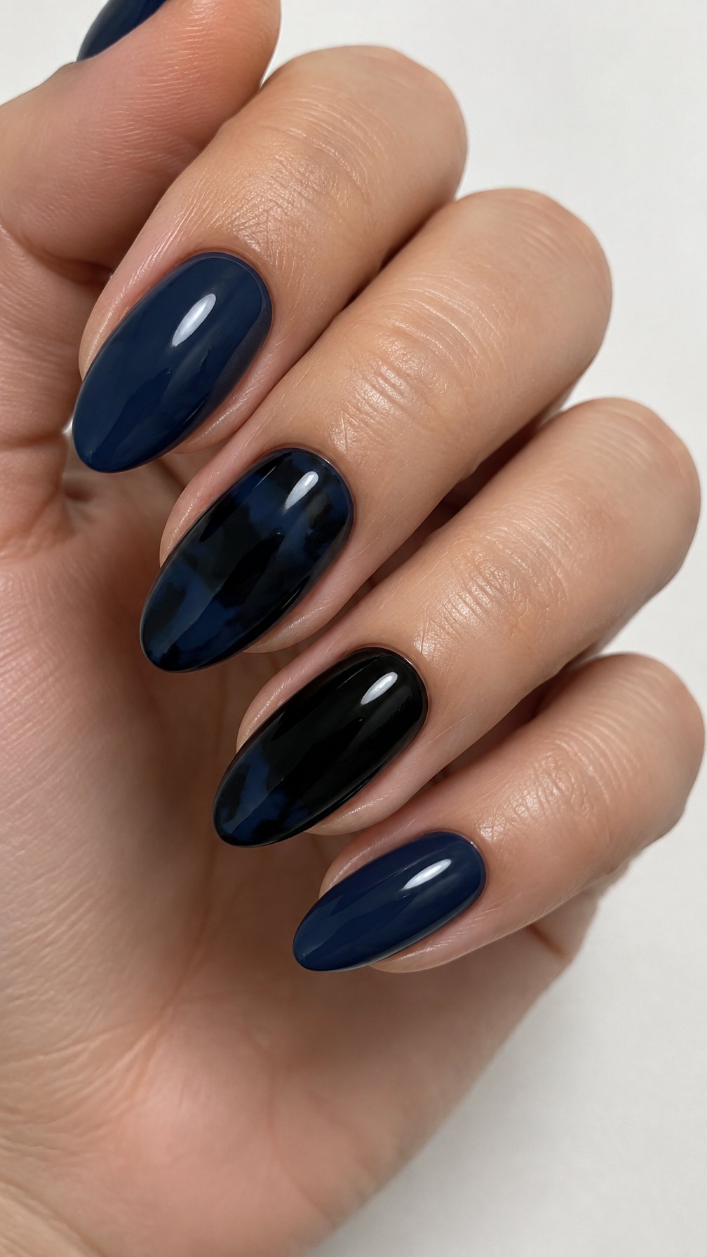 Glossy navy, black, and tortoiseshell patterned nails