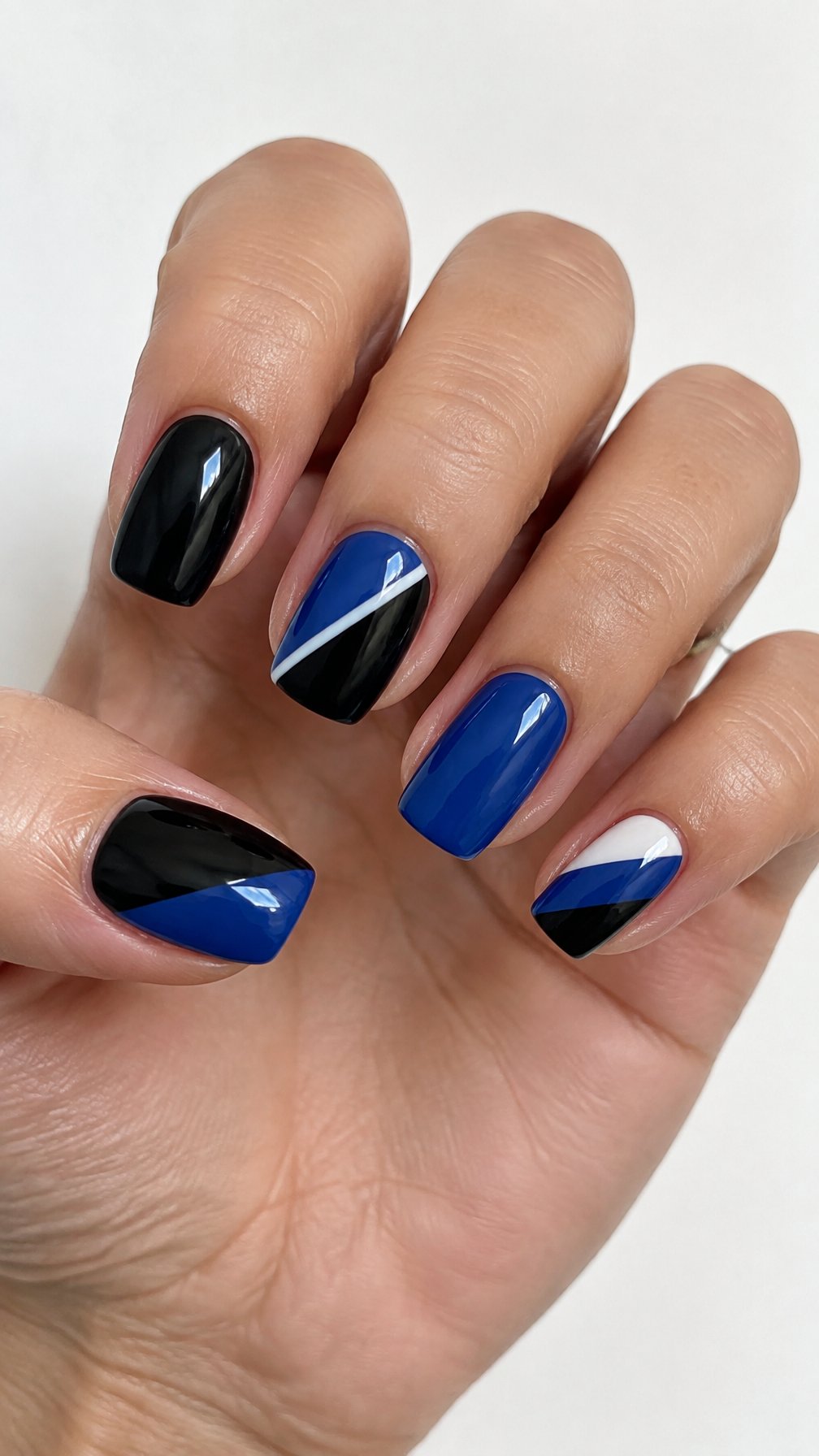 Glossy black and blue geometric nail designs