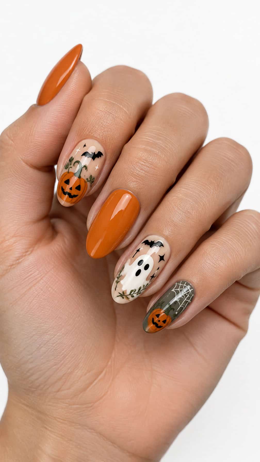 Halloween-themed nails decorated with pumpkins, ghosts, bats, and small stars
