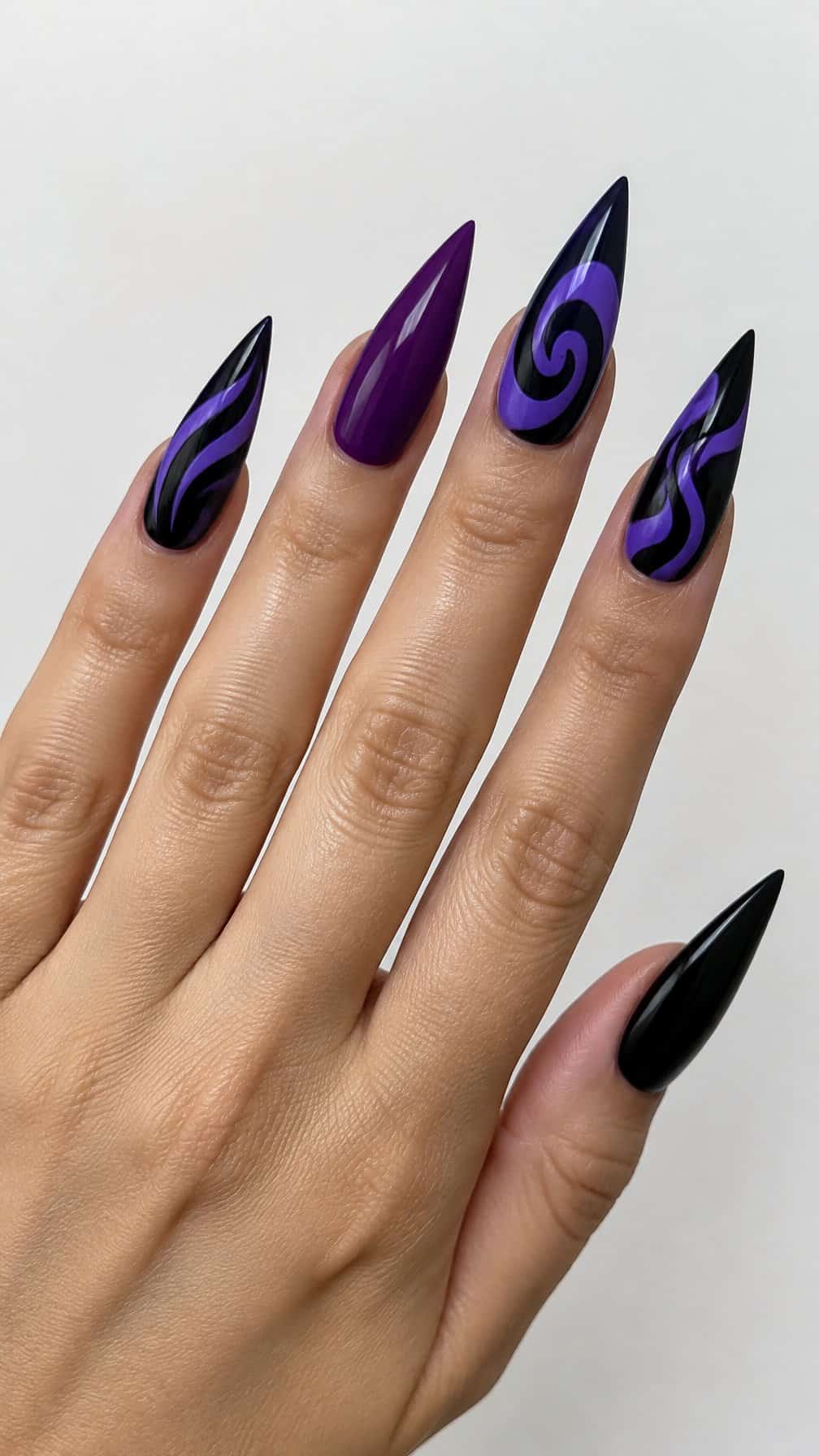 Long purple and black stiletto-shaped nails