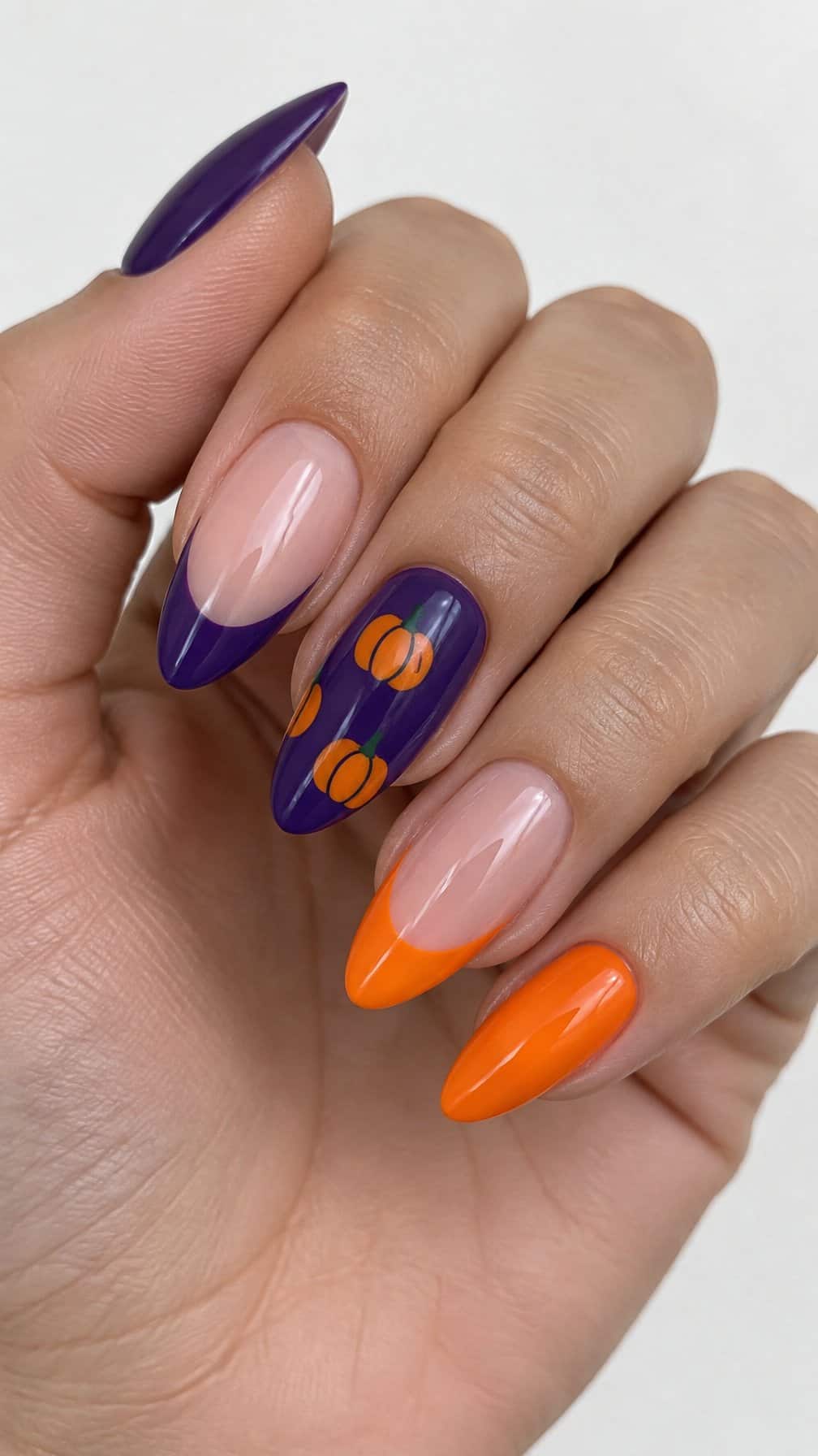 Glossy purple and orange pumpkin French-tip manicure
