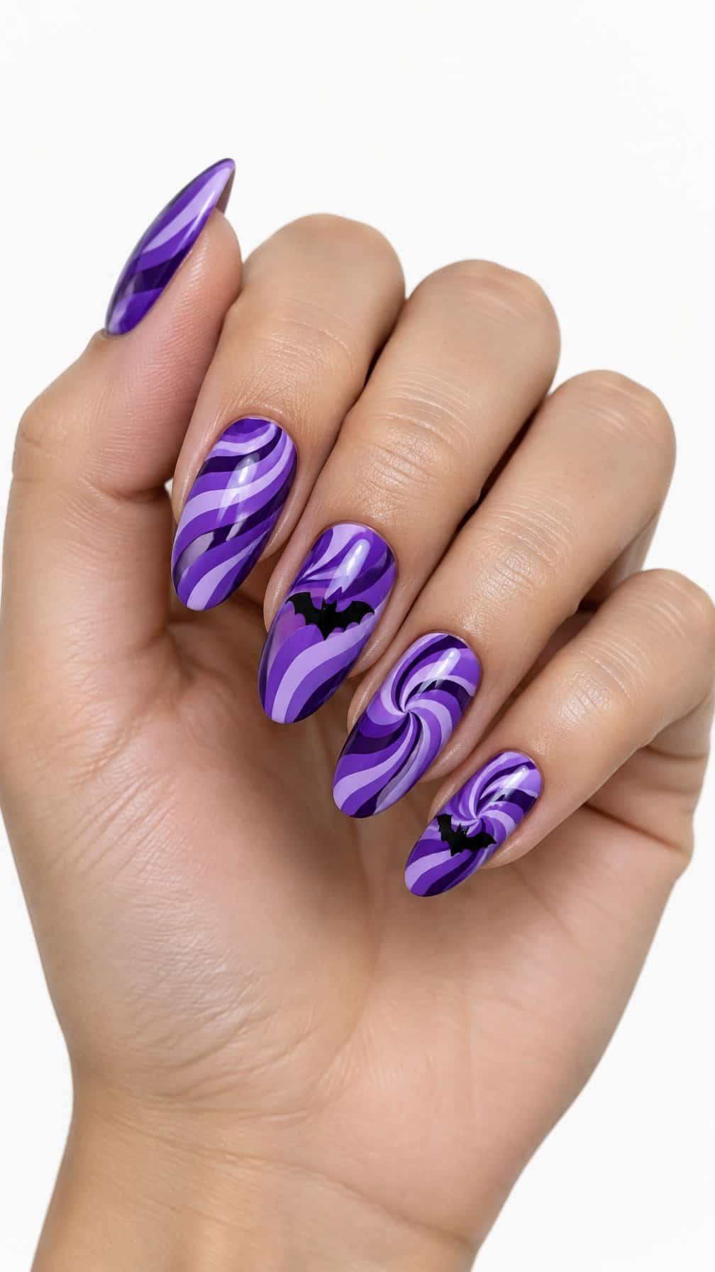 Glossy purple swirl nails and small black bat designs