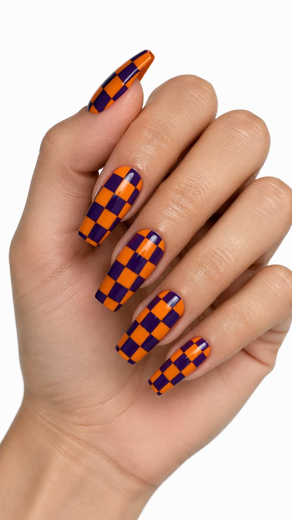 Purple and orange checkerboard nail art on glossy manicured nails