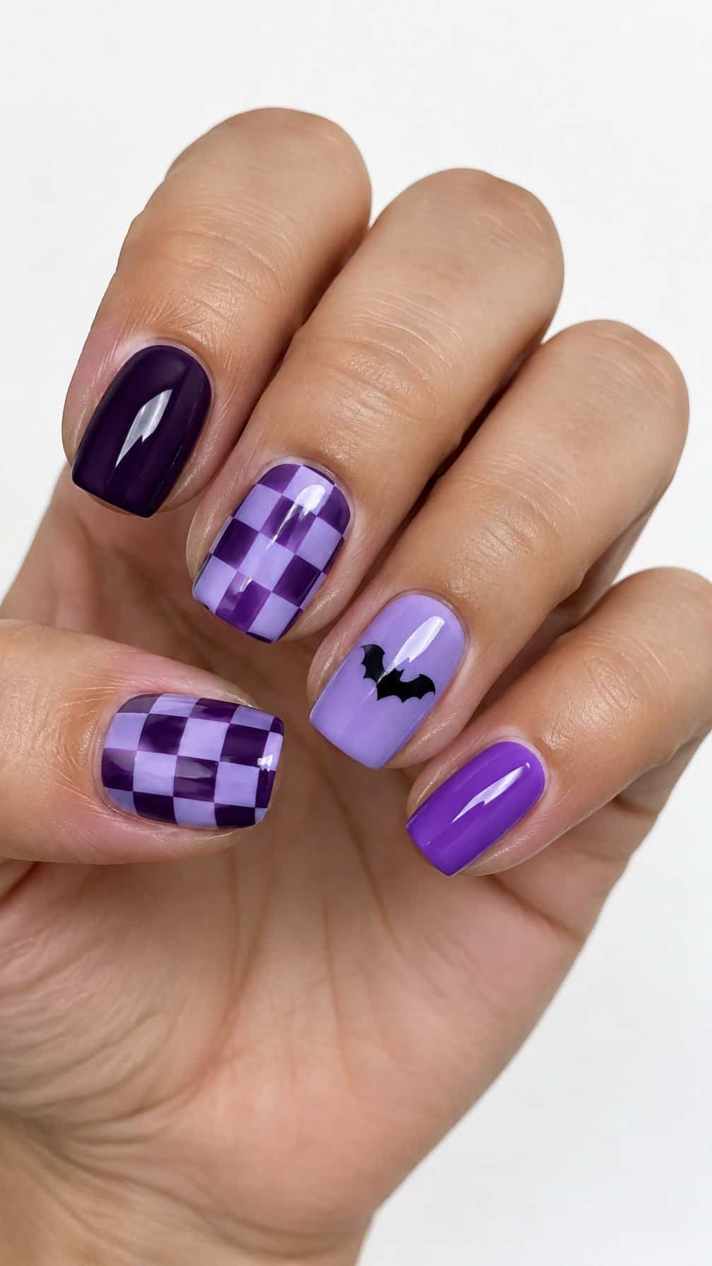 Glossy purple checkerboard Halloween nail designs