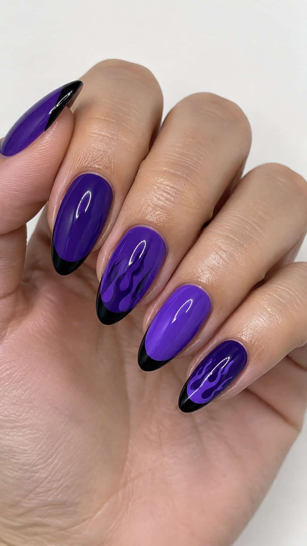 Glossy purple nails, black French tips, and purple flame designs