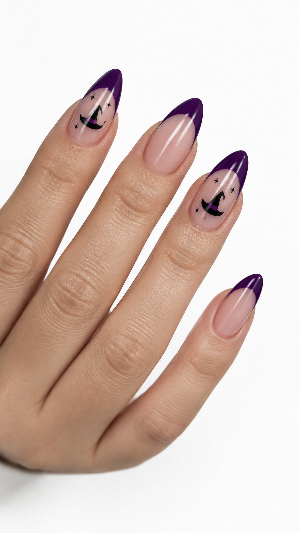 Glossy purple French-tip nails decorated with small black witch-hat designs