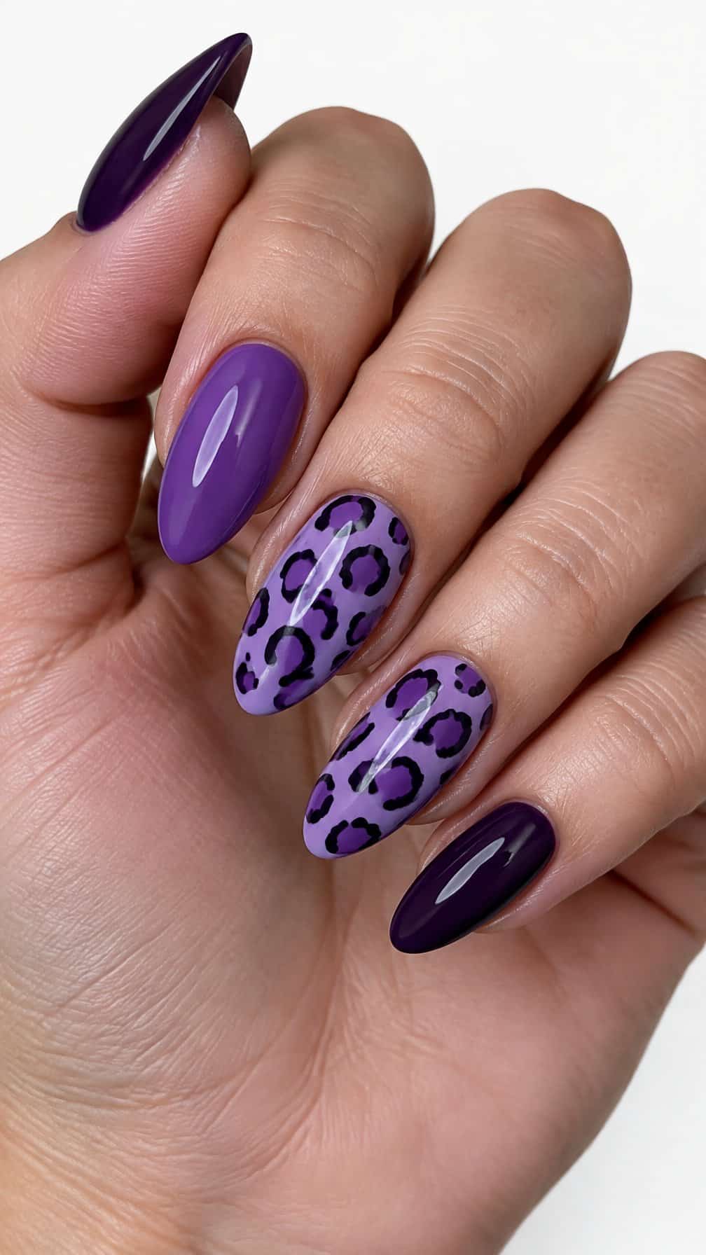 Glossy purple leopard print manicure