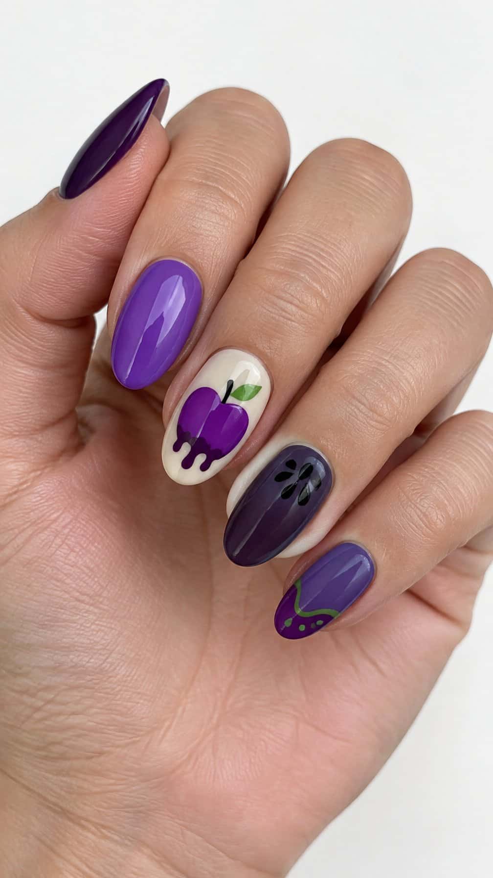 Glossy purple Halloween-themed nail art