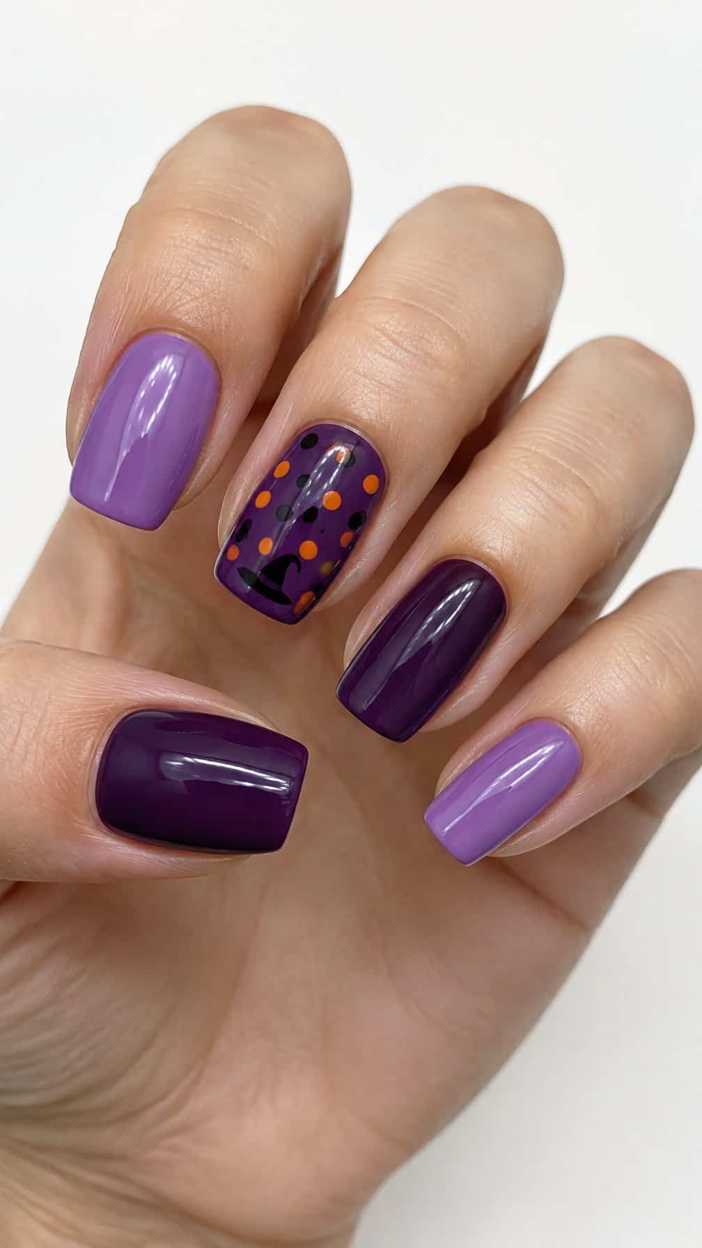 Glossy purple Halloween-themed painted nails
