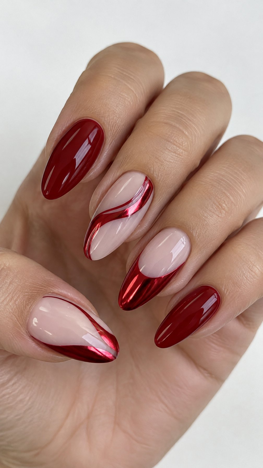 Glossy red chrome swirl nails and natural negative-space designs