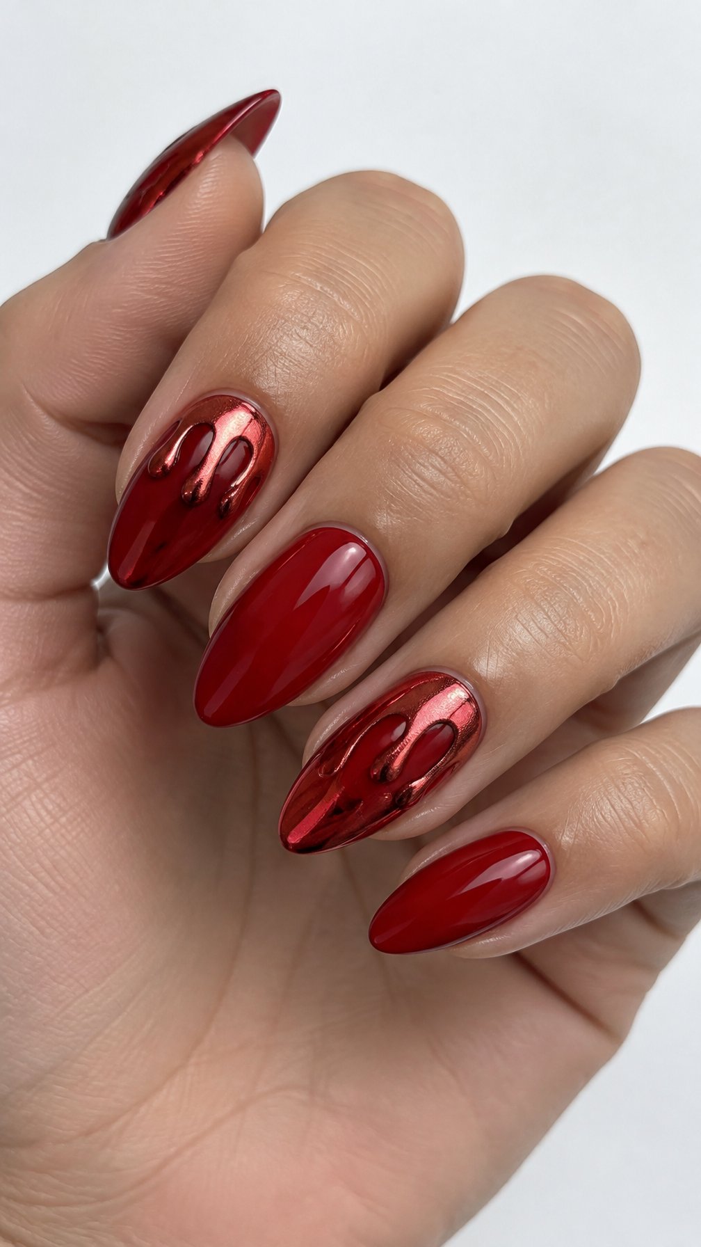 Glossy red nails featuring metallic red drip designs