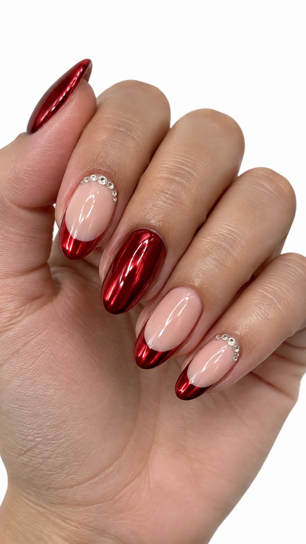 Glossy red French-tip nails and small rhinestones near the cuticles