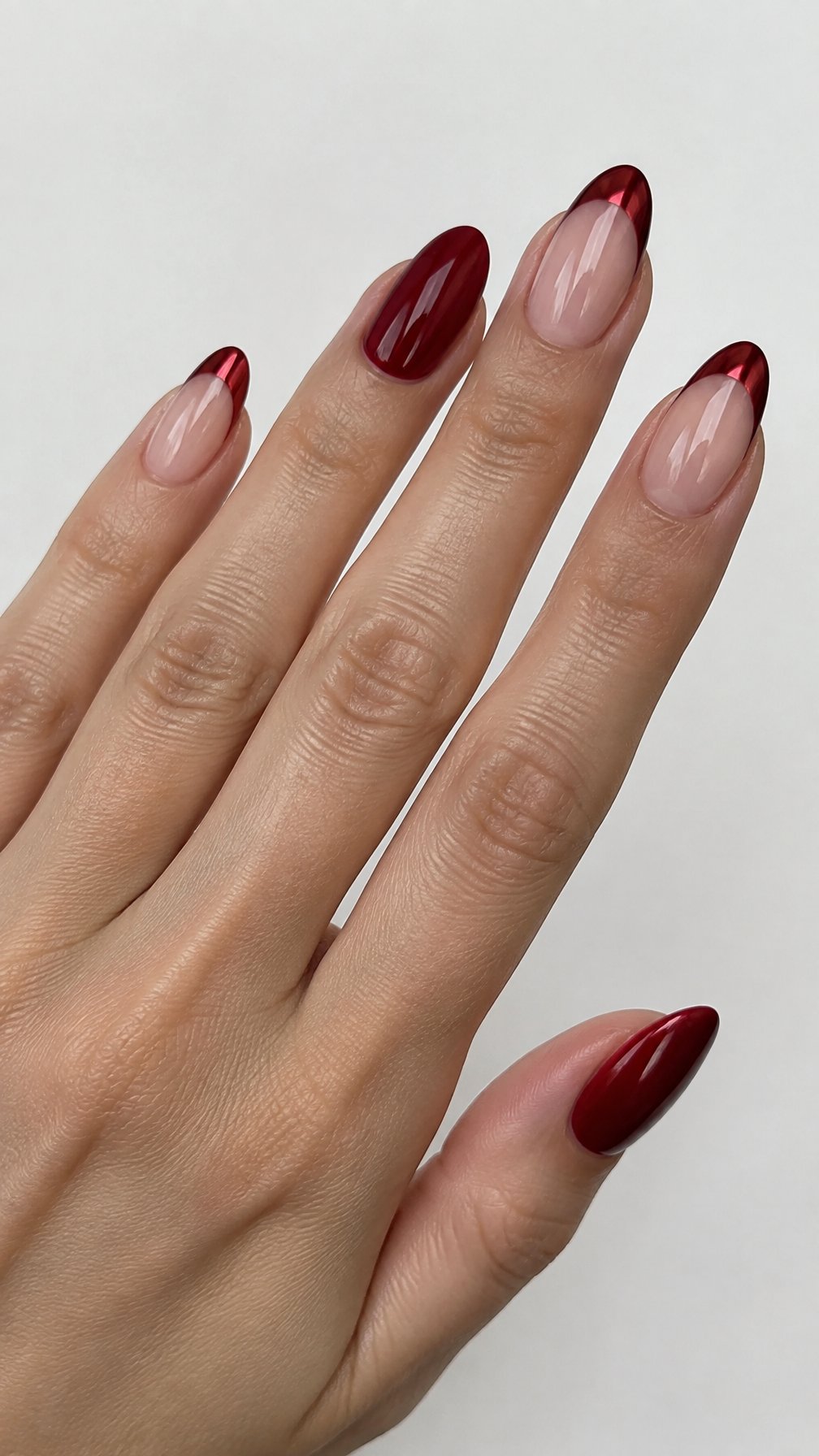 Crimson French-tip nails on a nude base