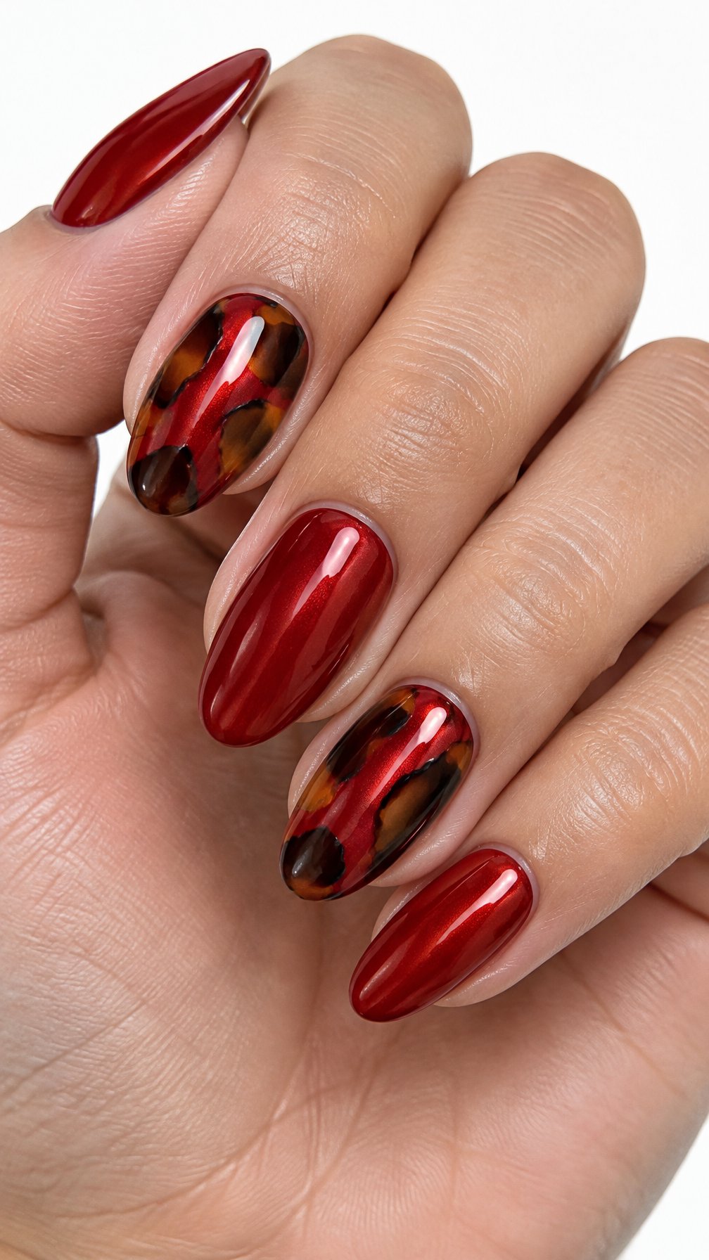 Glossy red nails and tortoiseshell accent nails