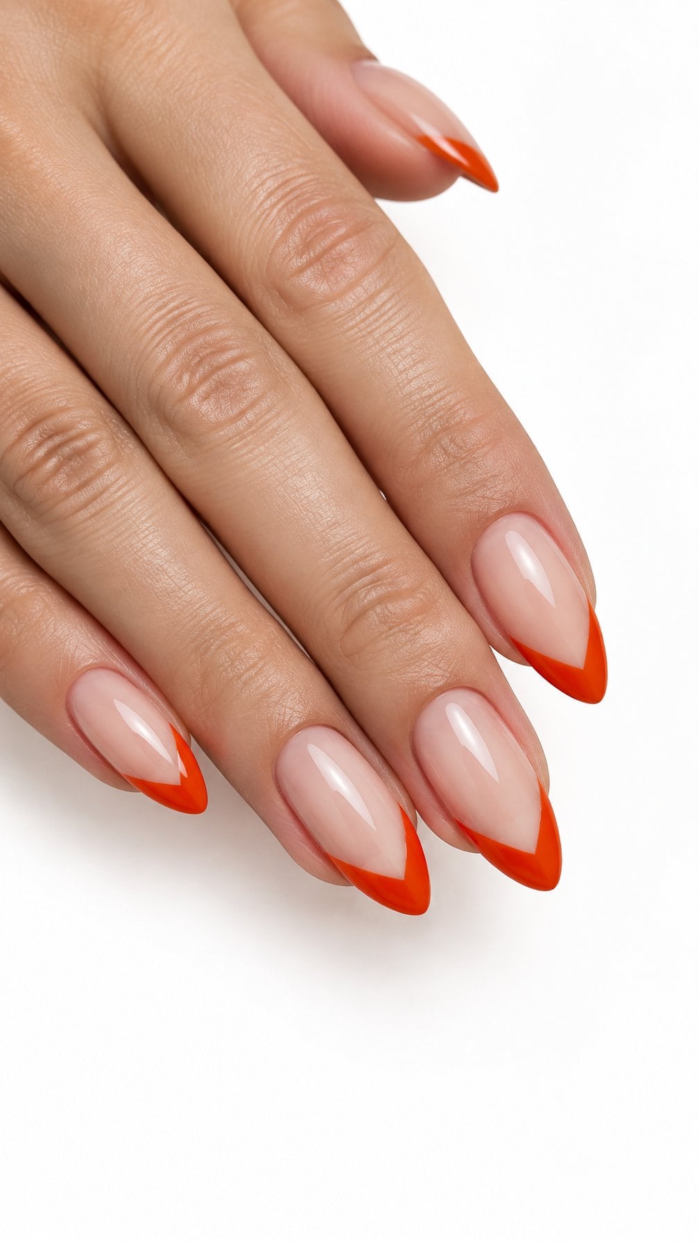 Glossy nude nails featuring blood-orange V-shaped French tips