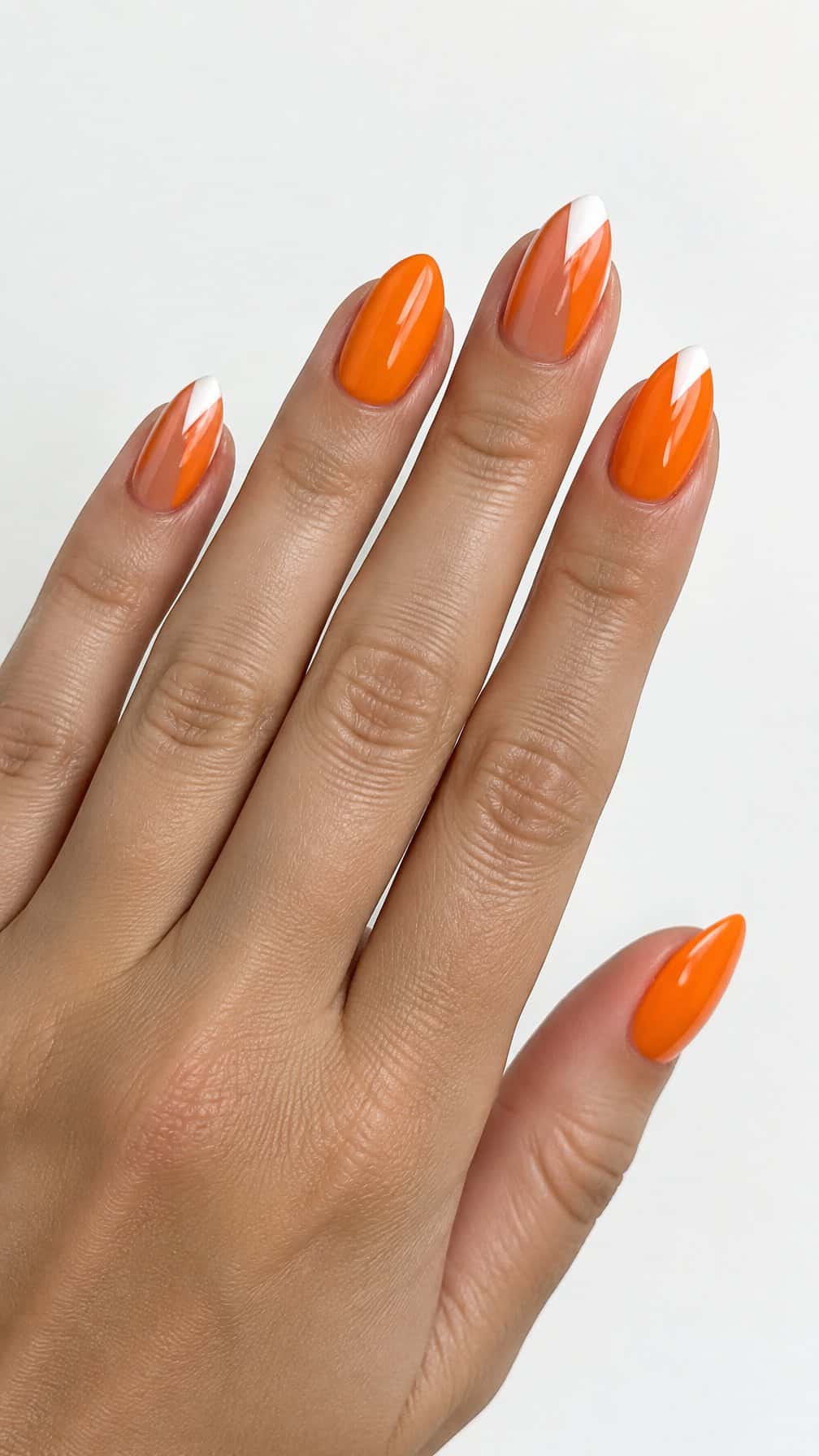 Glossy orange manicured nails with pointed French tip designs