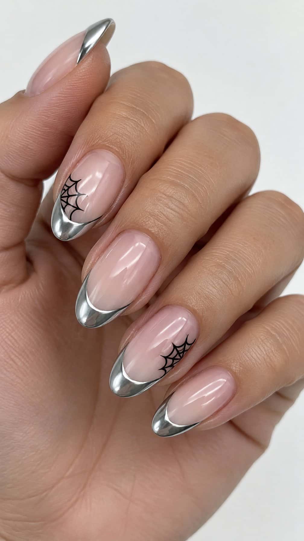 Glossy silver French-tip nails with black cobweb designs