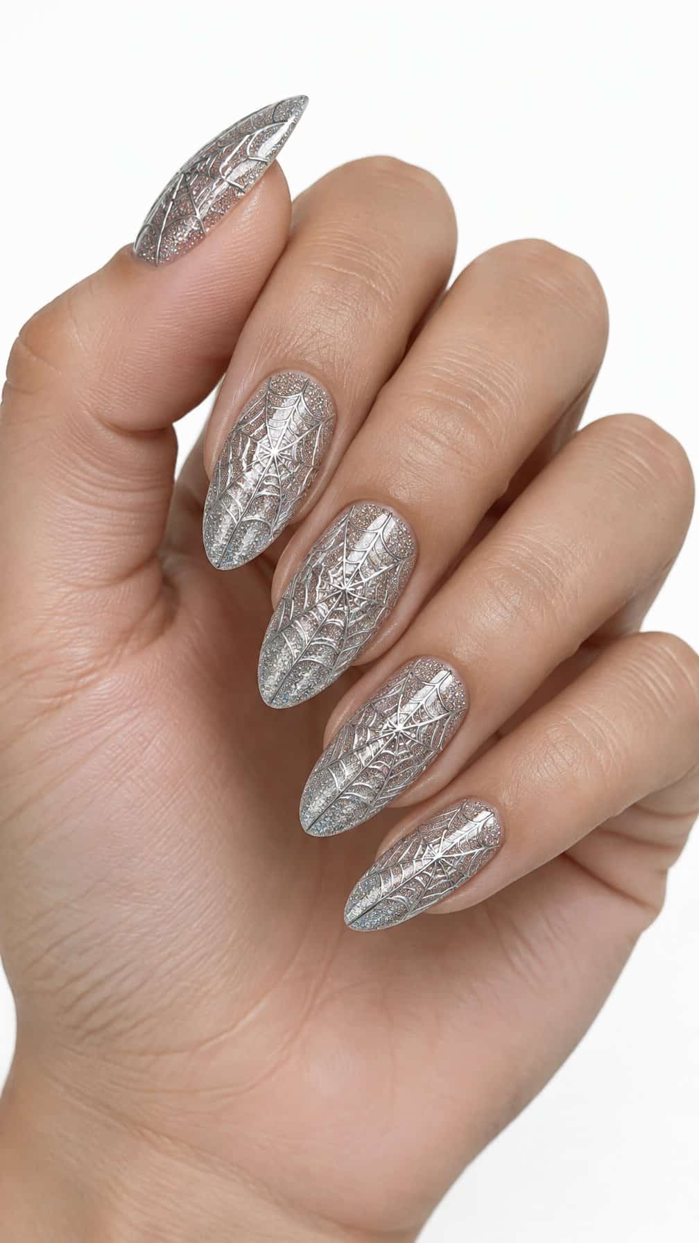 Sparkling silver nails decorated with delicate spider web designs