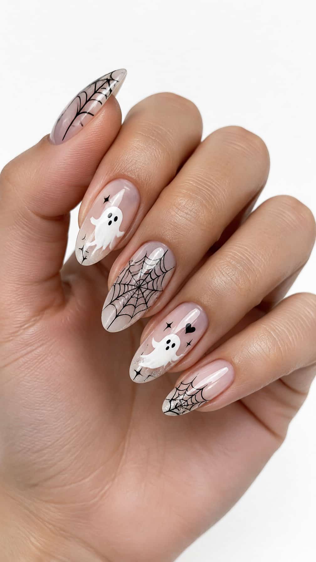 Glossy black-and-white Halloween nails decorated with spider webs and small ghost designs