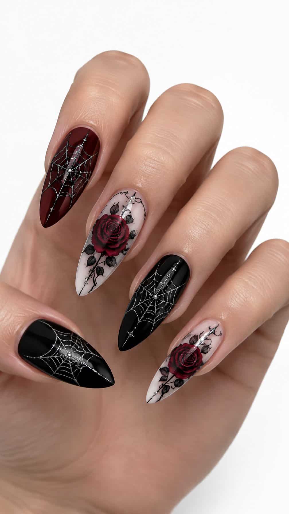 Black, burgundy, and pale nails decorated with spider webs and roses
