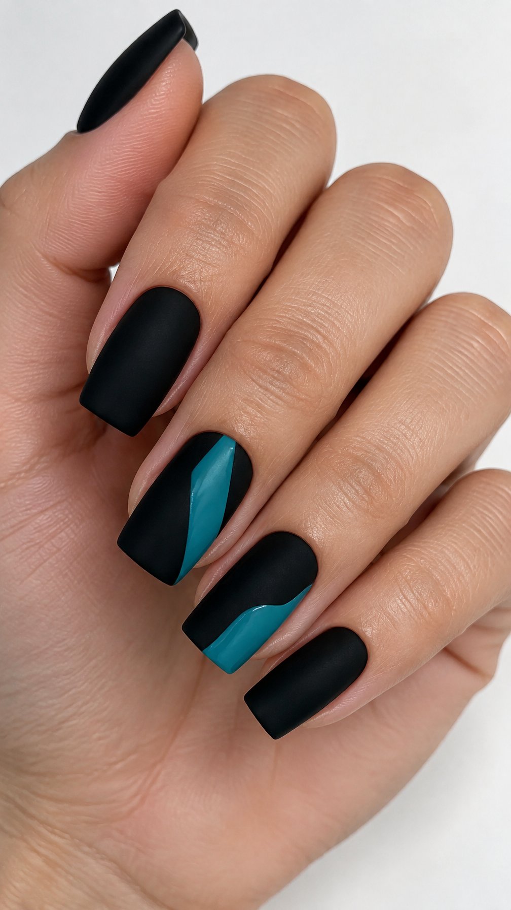 Short black and teal painted gel nails