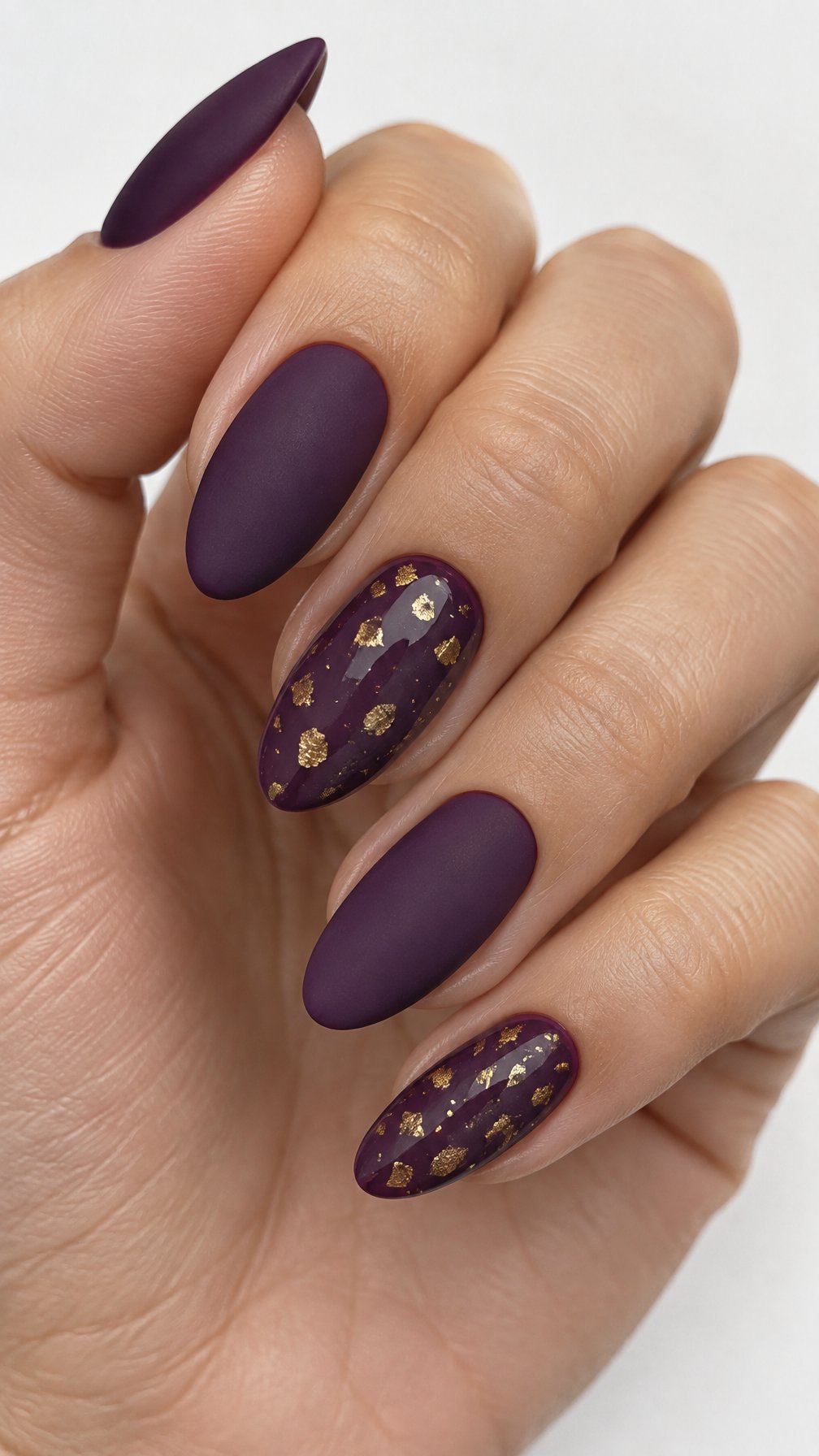 Purple manicure and small gold flakes on accent nails