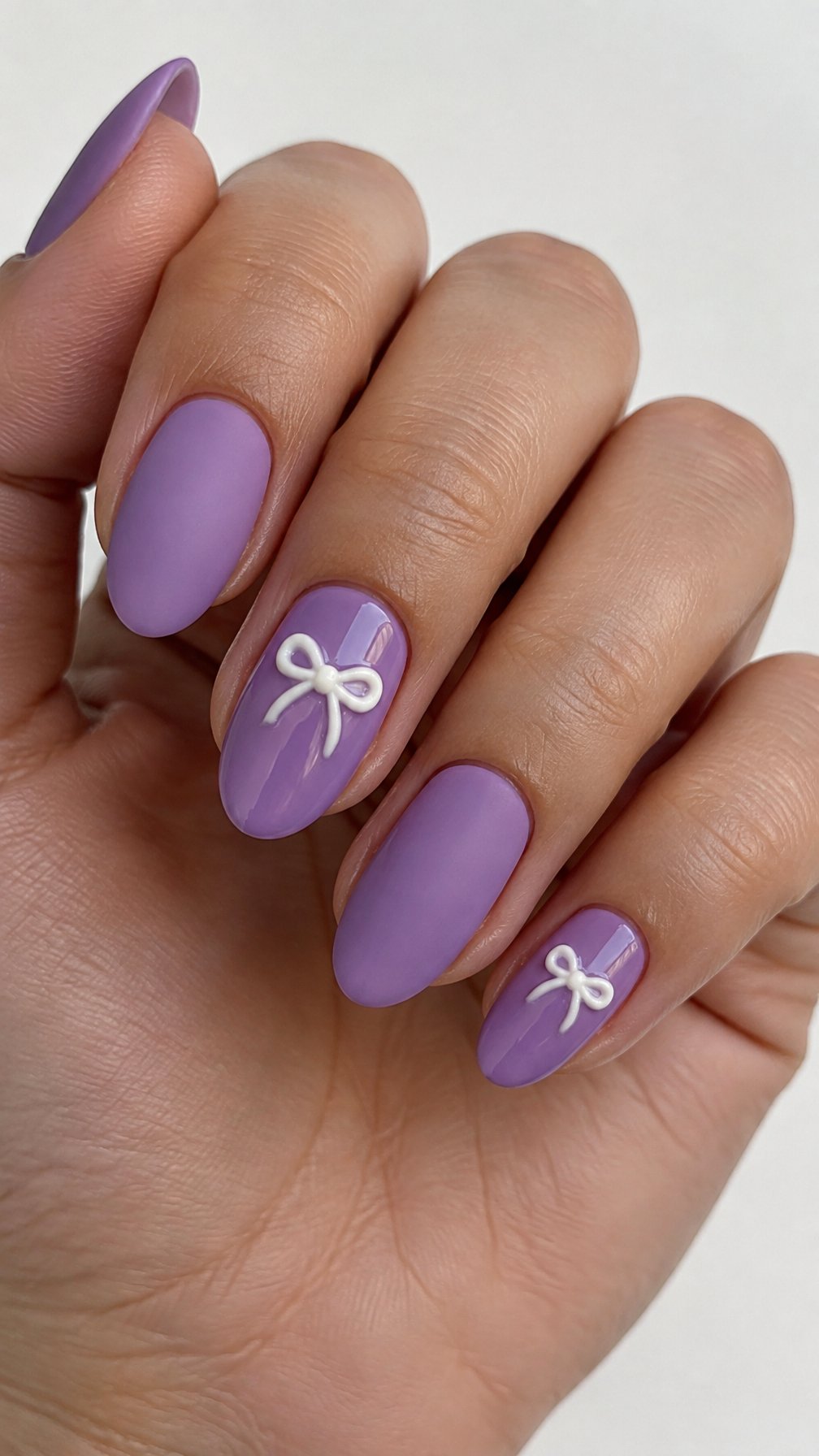 Matte orchid-purple nails and small white bow accents