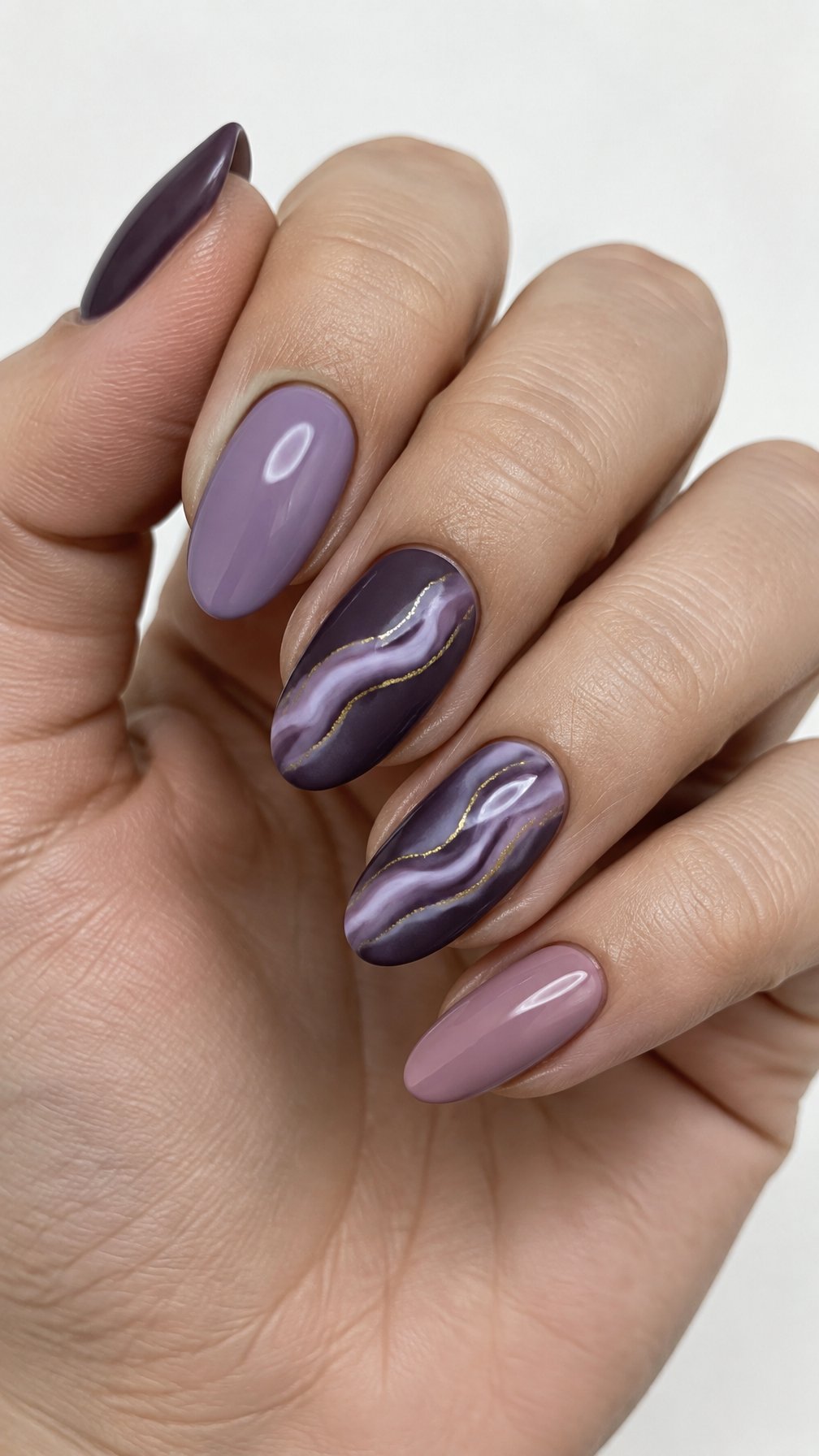 Purple marble manicure nails accented by thin gold veins