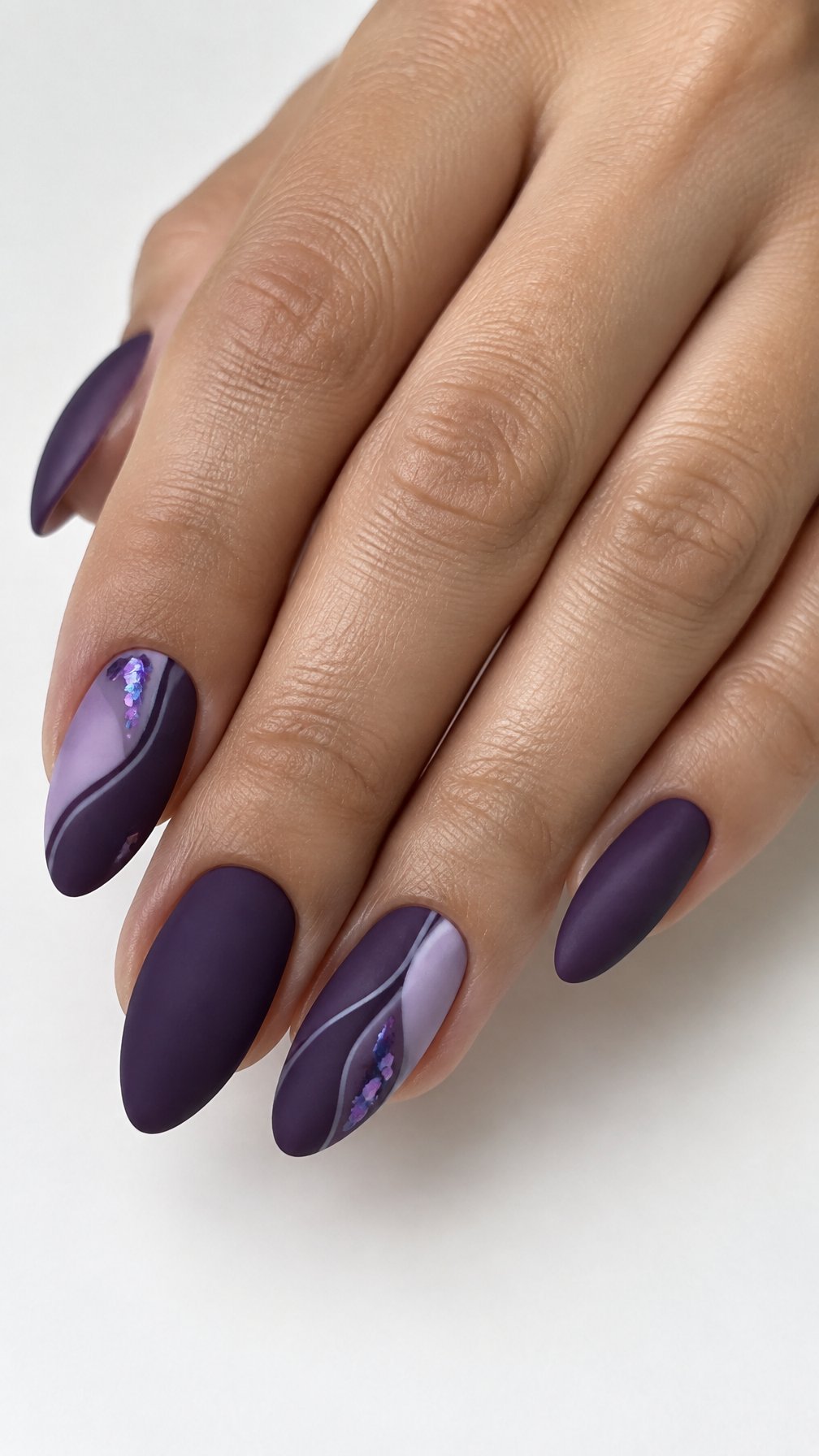 Matte purple almond-shaped nails featuring small iridescent accents