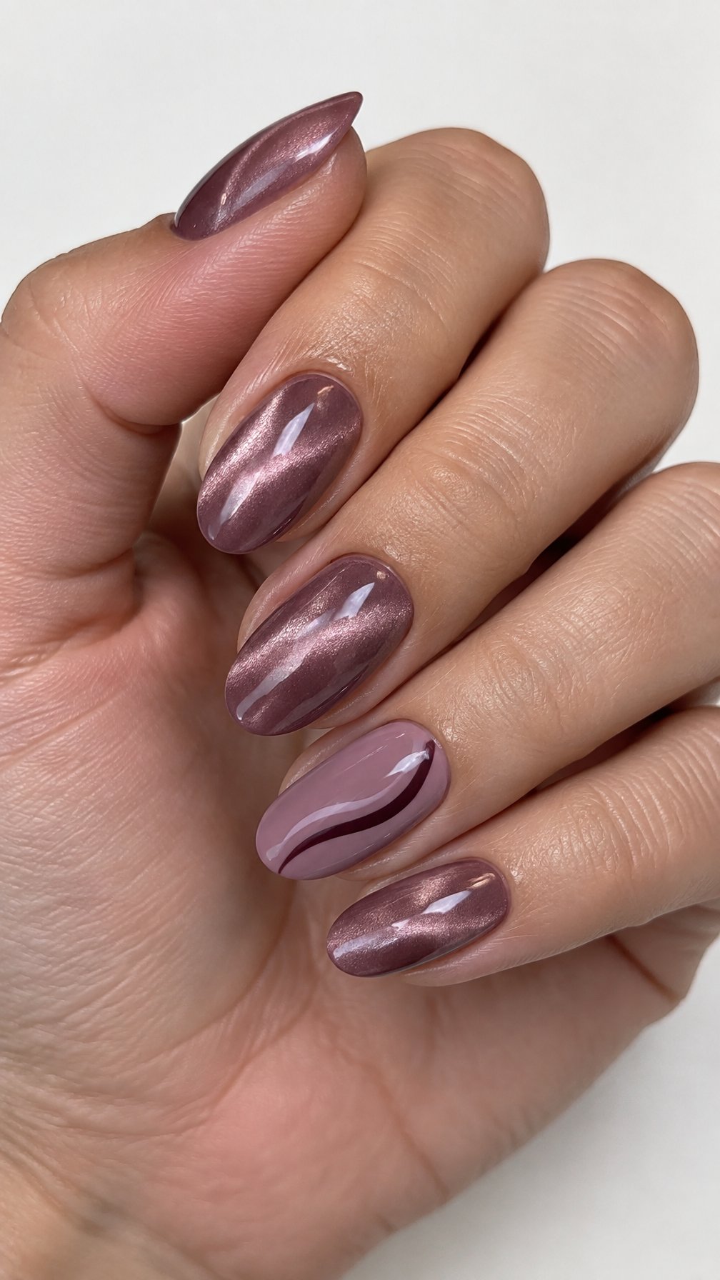Glossy mauve manicure nails featuring subtle cat-eye accents