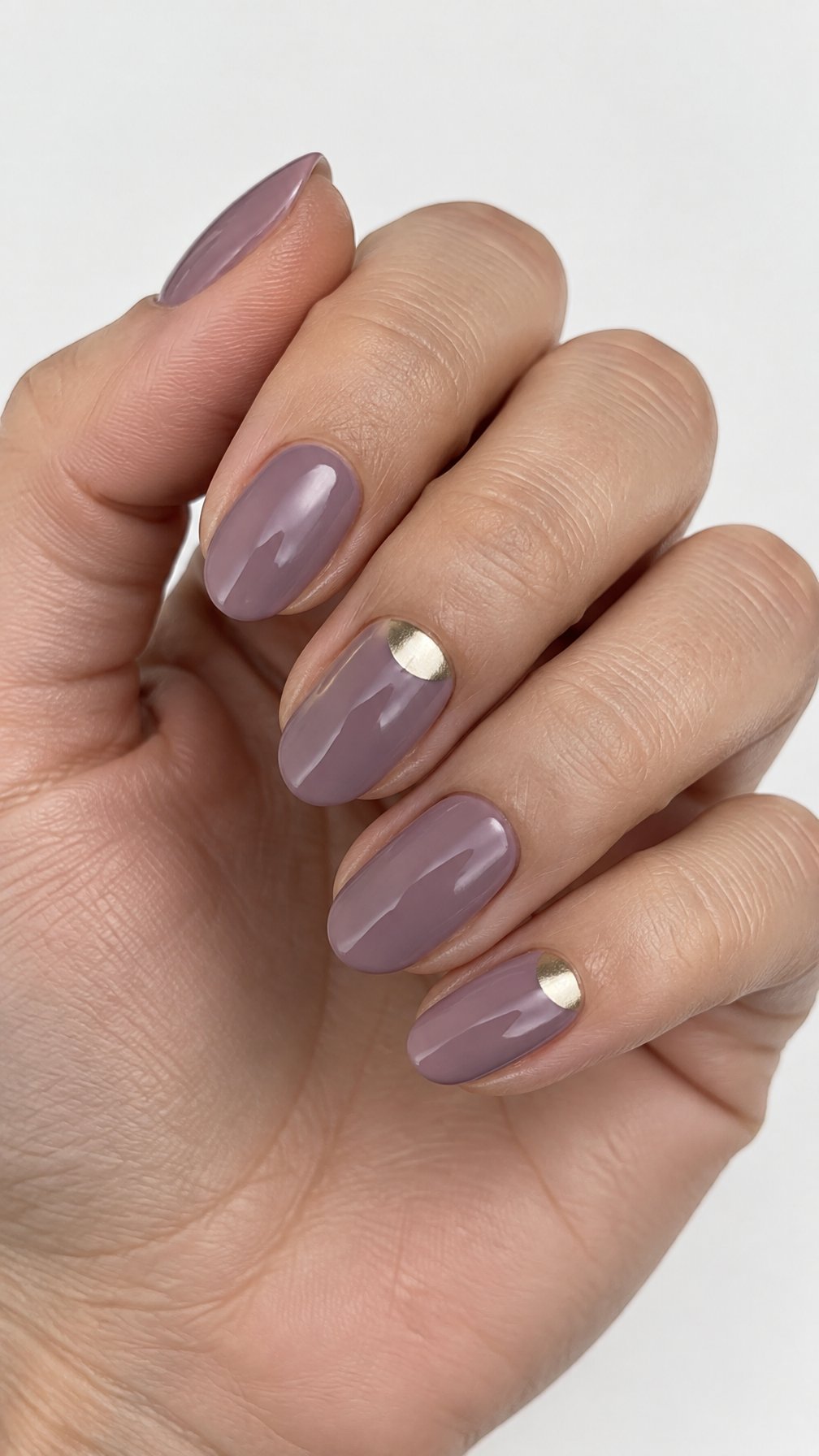 Glossy mauve half-moon manicure and gold accents