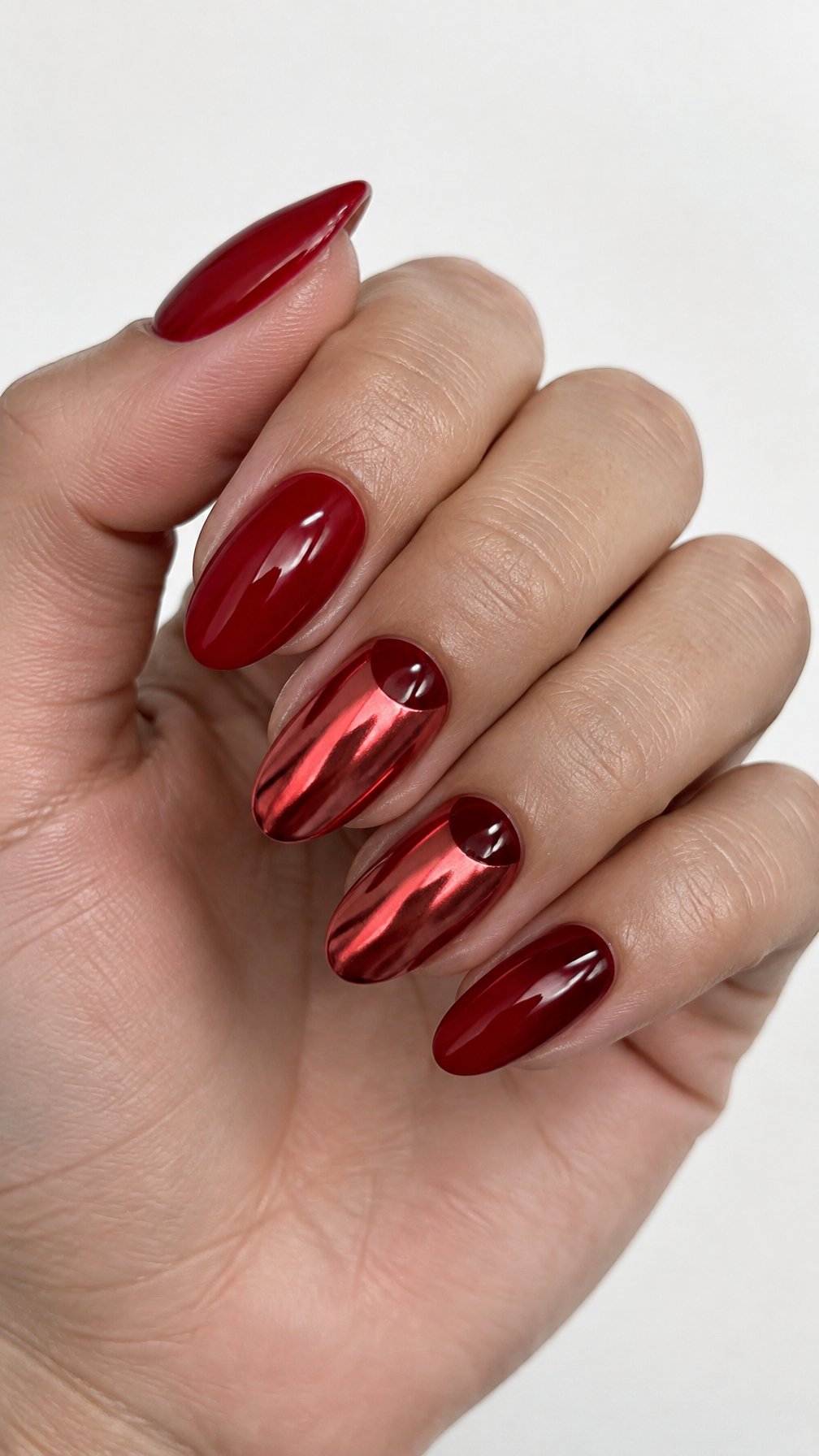 Glossy red chrome half-moon manicure
