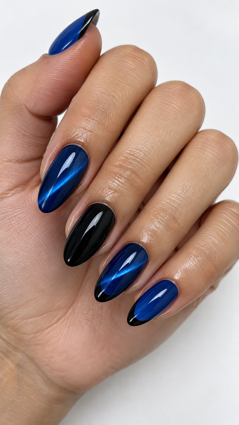 Glossy sapphire-blue cat-eye gel nails and black accent designs