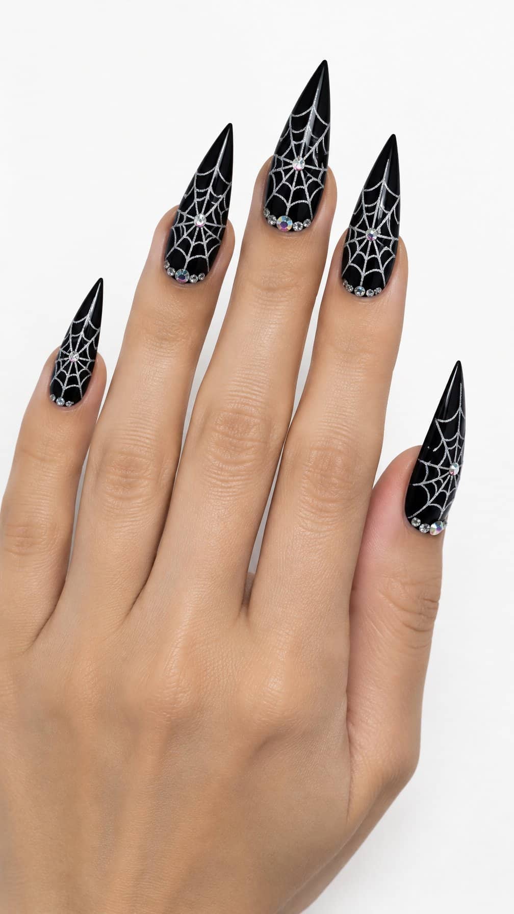 Long stiletto nails decorated with black spider webs and sparkling rhinestones