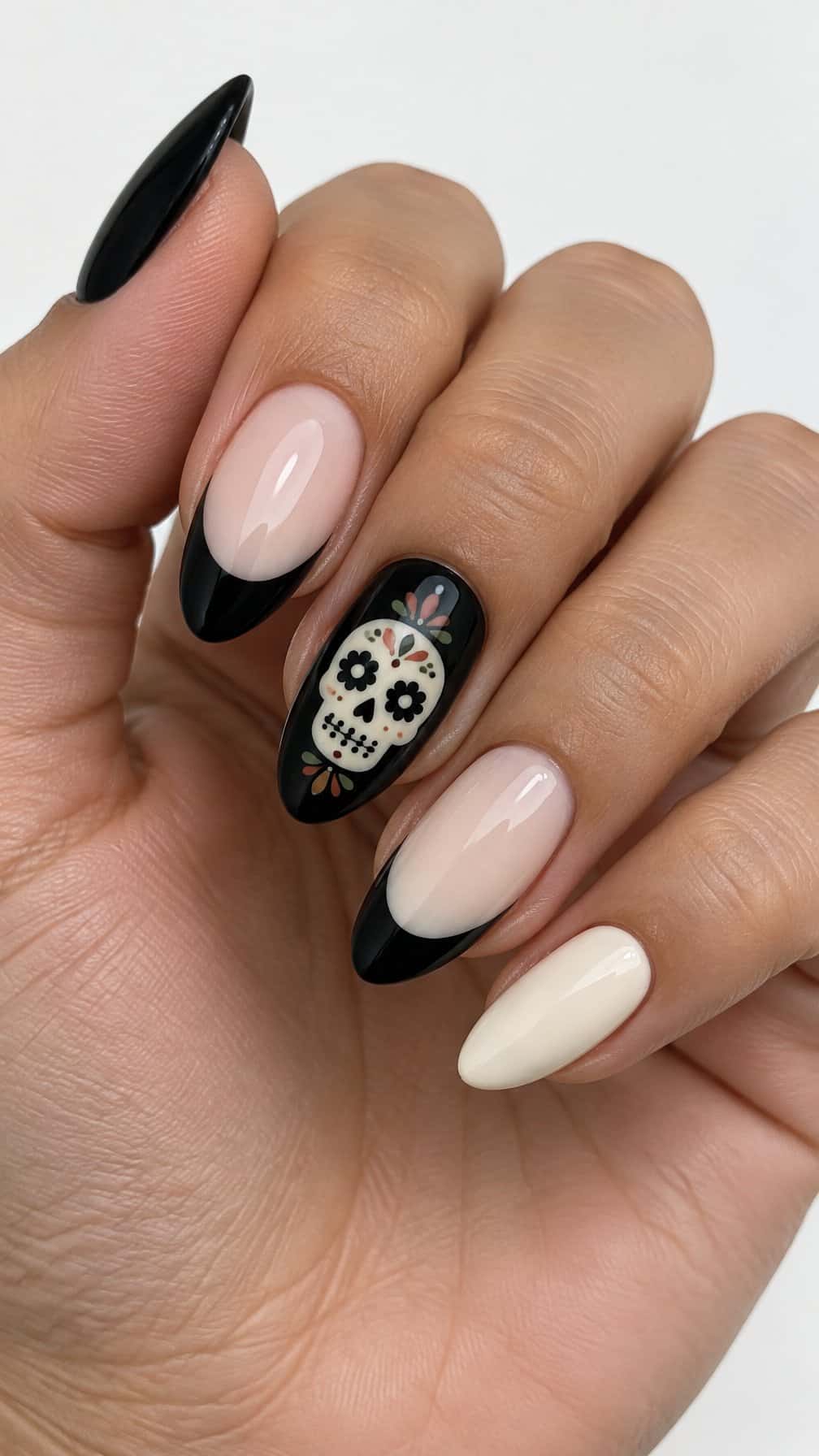 Glossy black French-tip nails and small sugar skull designs