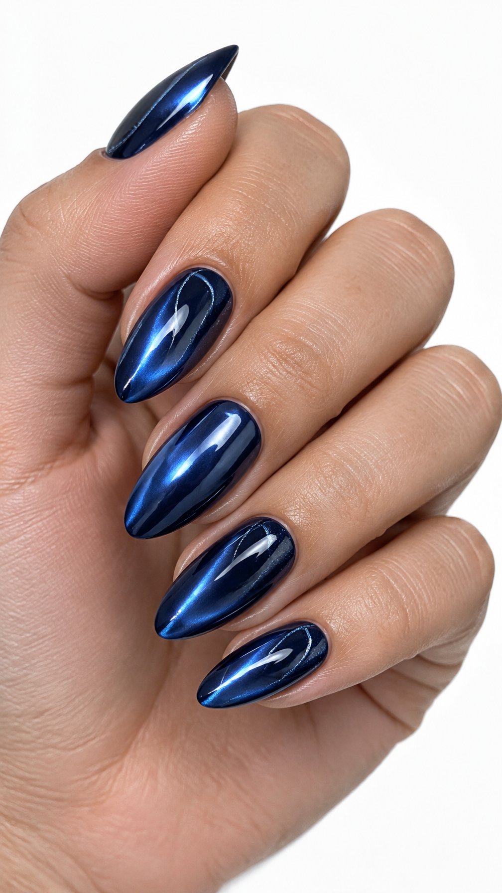 A single hand with glossy midnight blue chrome almond-shaped nails against a white background.