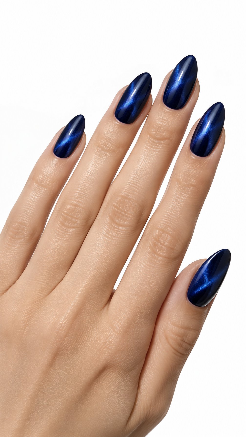 A single hand displays glossy midnight blue cat-eye manicure on almond-shaped nails against a white background.