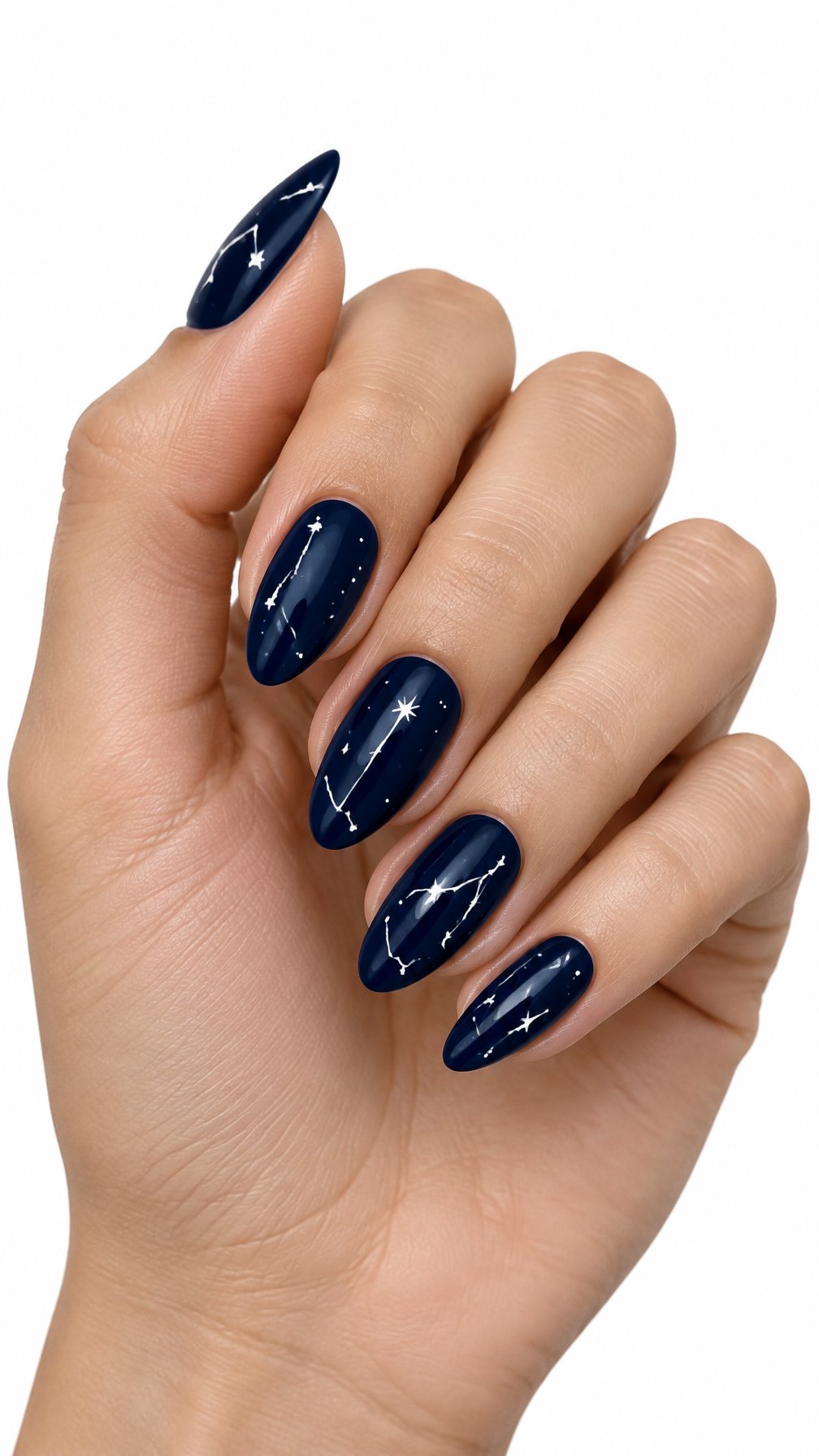 A single hand with glossy midnight blue nails decorated with tiny white constellations rests against a white background.