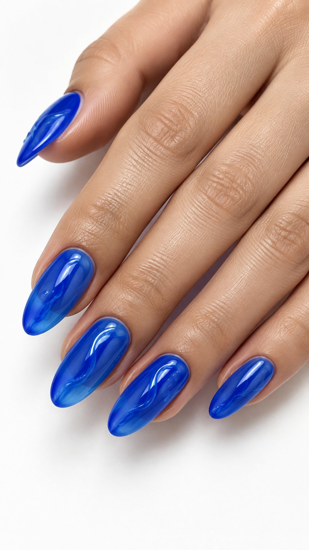 One hand with glossy translucent electric blue almond-shaped nails against a white background.