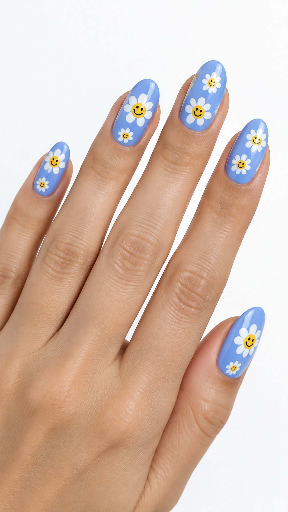 One hand with glossy periwinkle nails decorated with white daisies and yellow smiley-face centers against a white background.