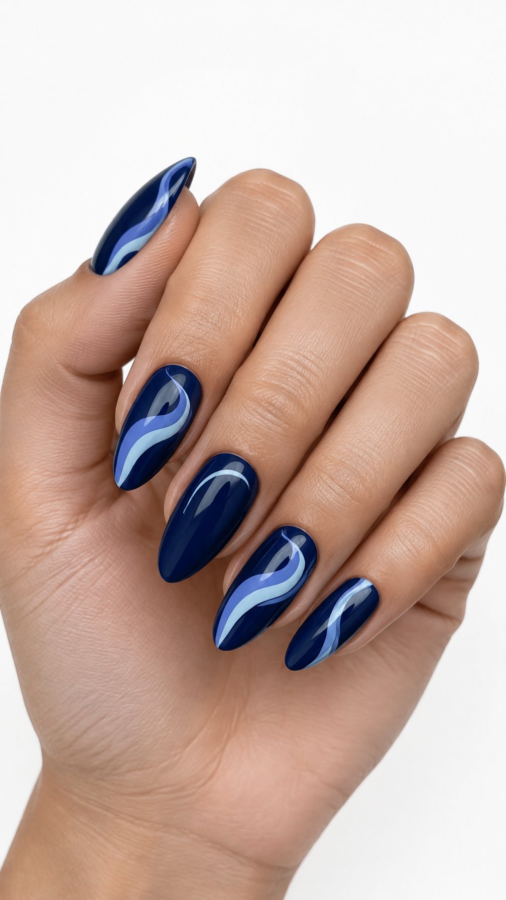 A single hand with glossy midnight blue nails decorated with baby blue and periwinkle swirling designs against a white background.