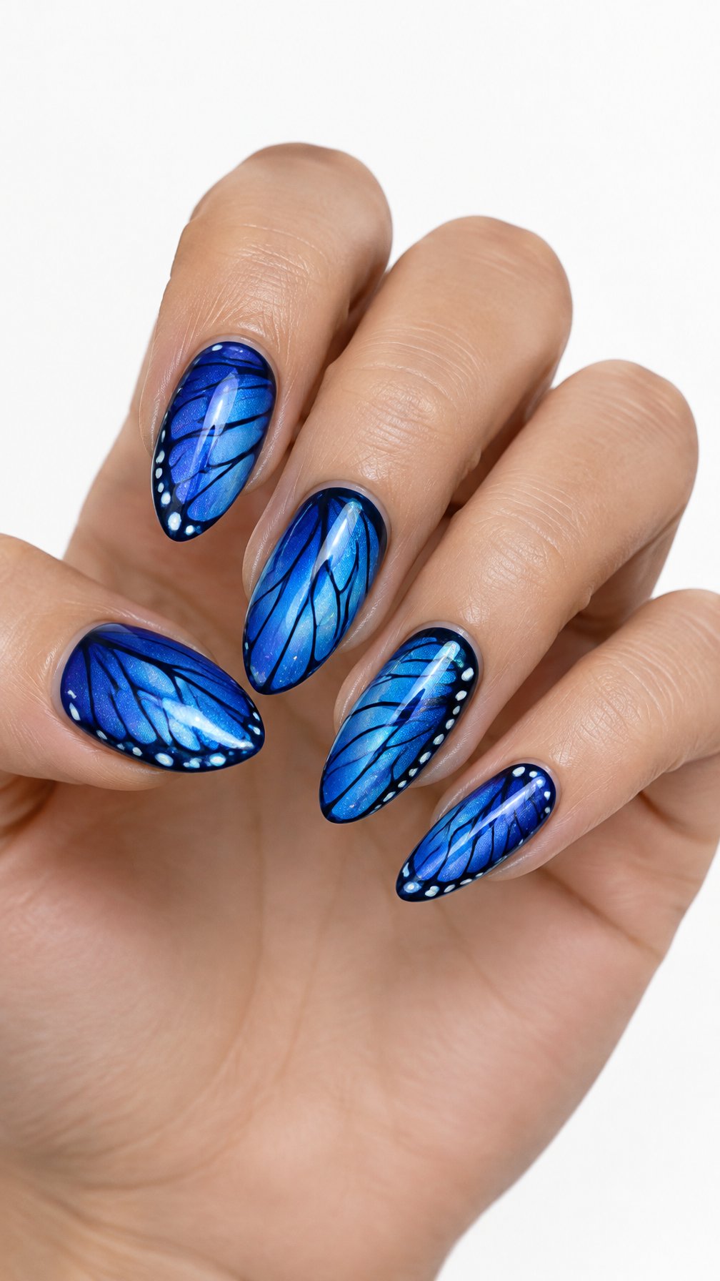 A single hand with glossy electric-blue butterfly wing designs on its manicured nails against a white background.