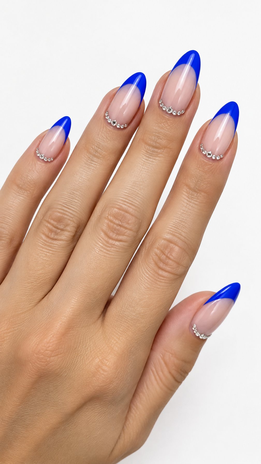 A single hand with glossy electric blue French tip nails and small rhinestones along the cuticles against a white background.