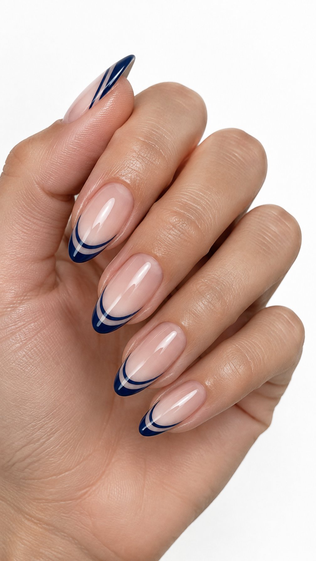 A single hand with glossy almond-shaped nails featuring deep blue double French tips on a white background.