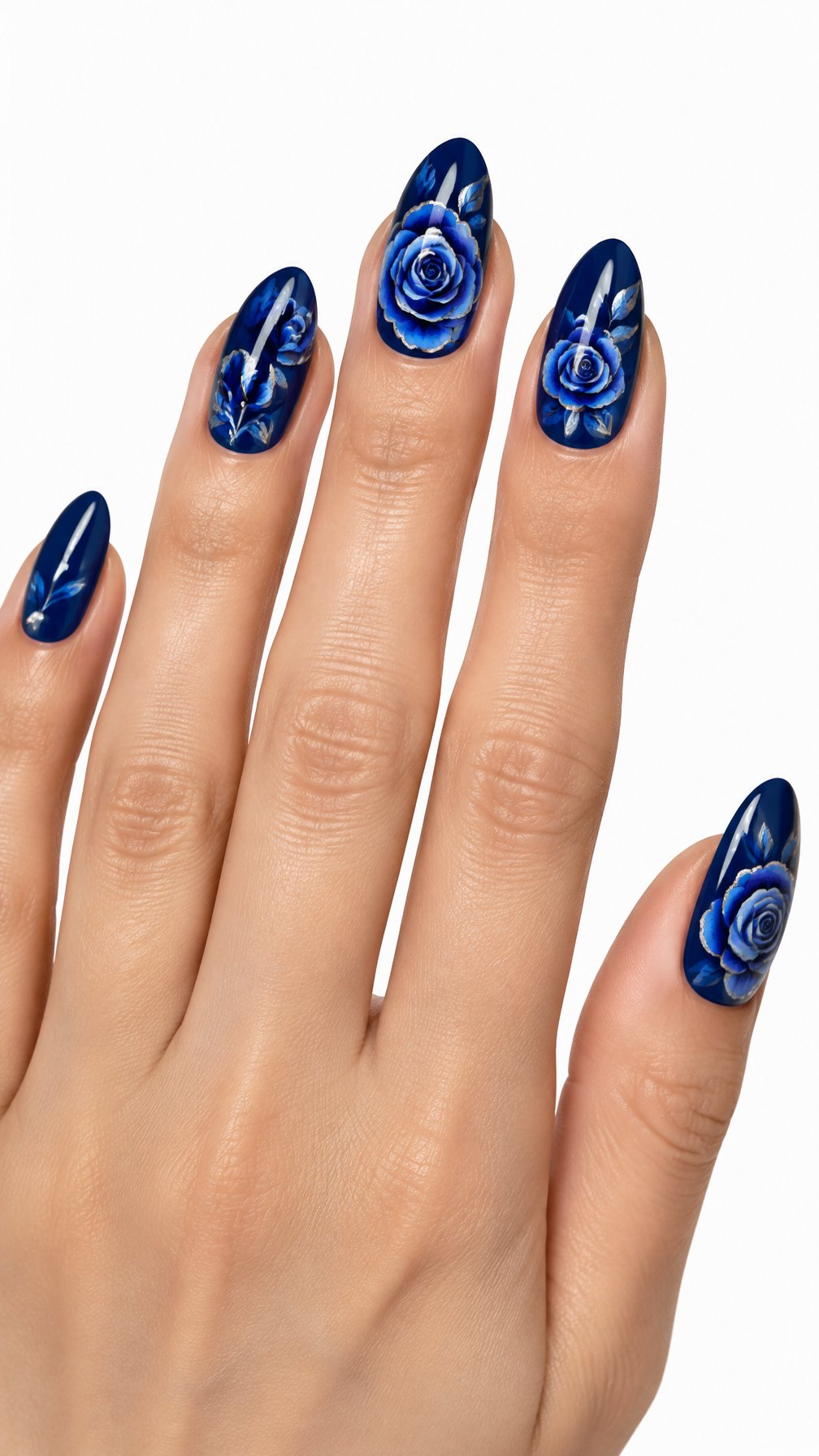 A single hand with glossy sapphire-blue nails decorated with blue roses and silver chrome accents on a white background.