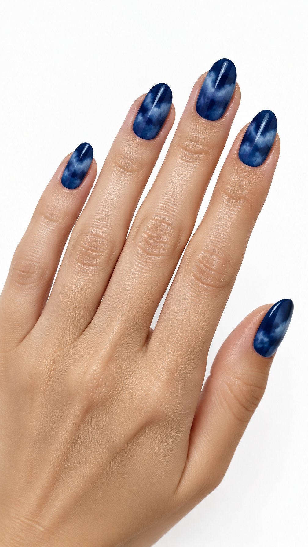 A single hand with glossy midnight blue nails decorated with soft watercolor cloud patterns against a white background.