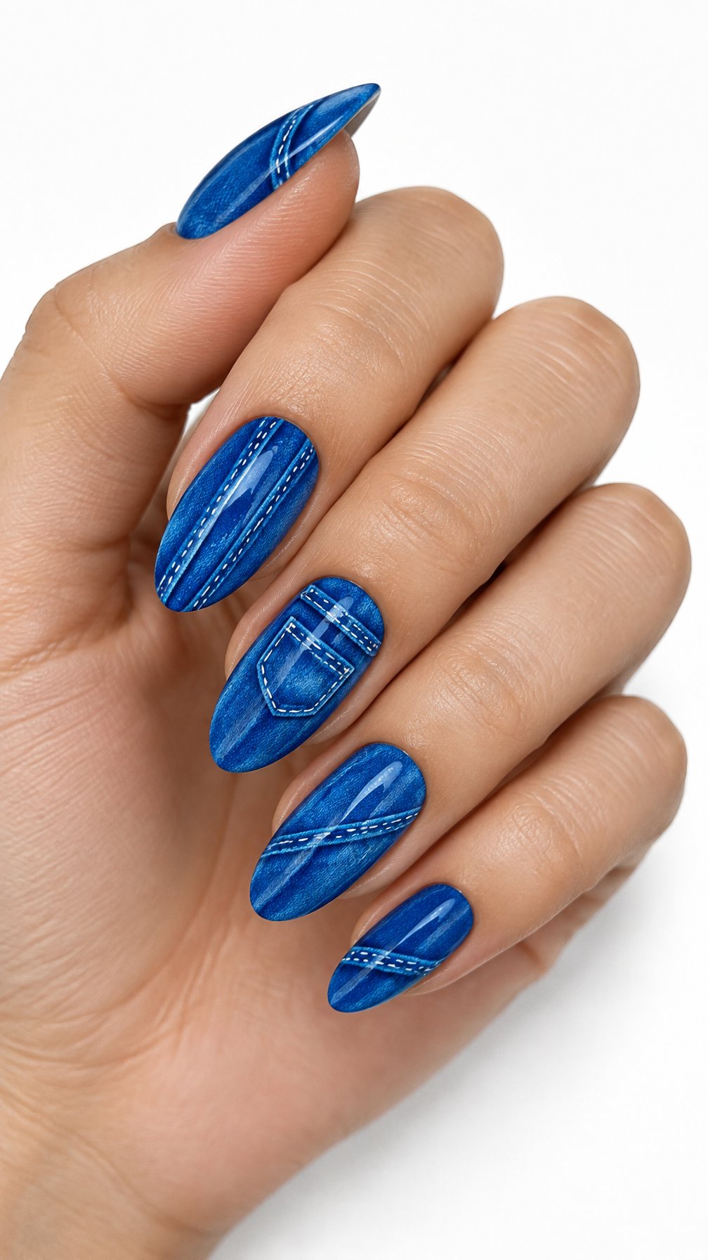 One hand with electric blue nails decorated with white denim-inspired stitching on a white background.
