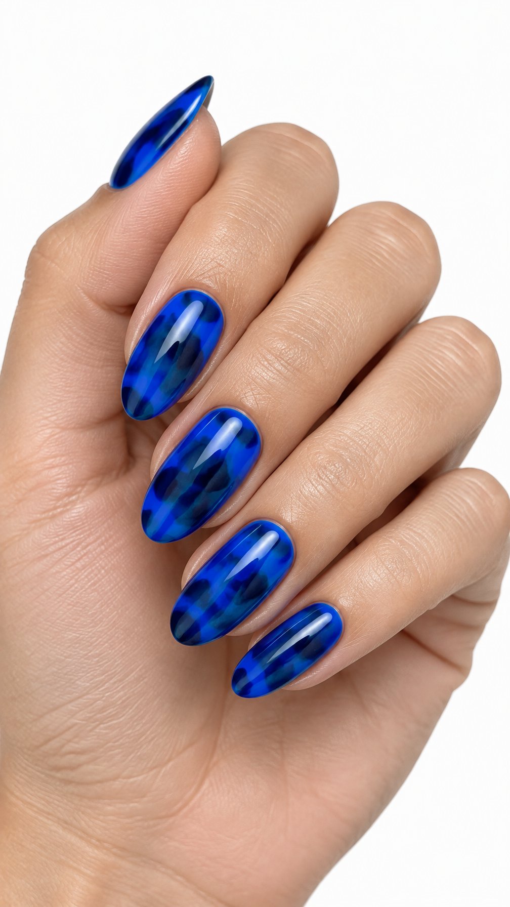 A single hand with glossy cobalt blue patterned nails against a white background.
