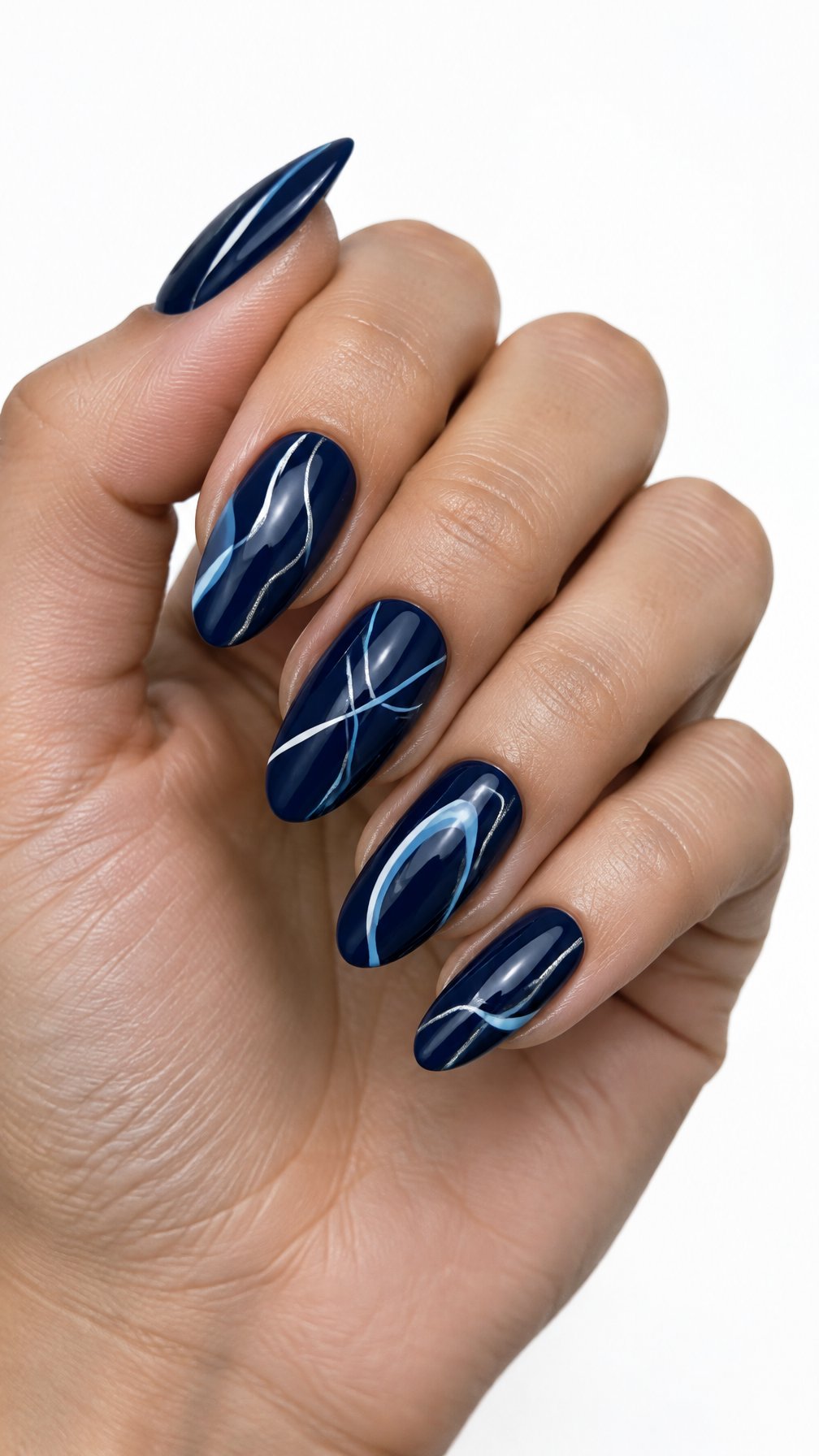 A single hand with glossy midnight blue nails decorated with delicate abstract line designs against a white background.