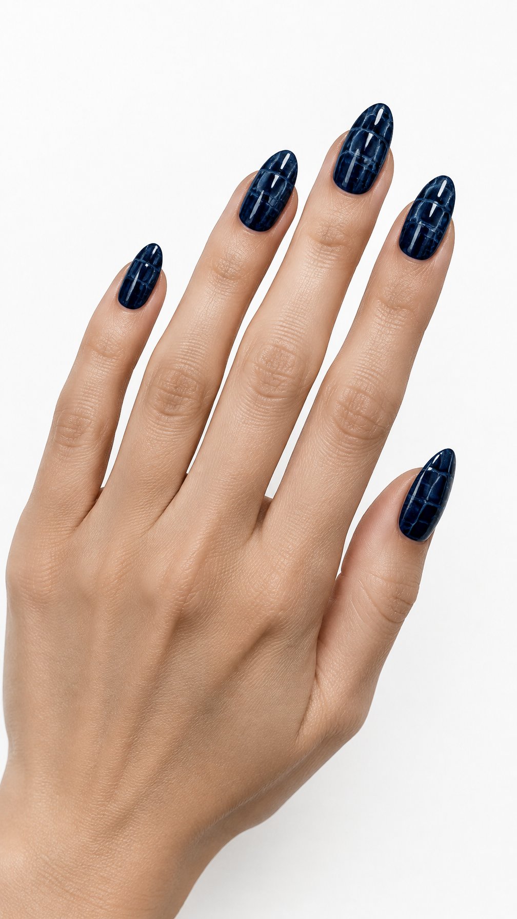 A single hand with glossy midnight blue textured nails rests against a white background.